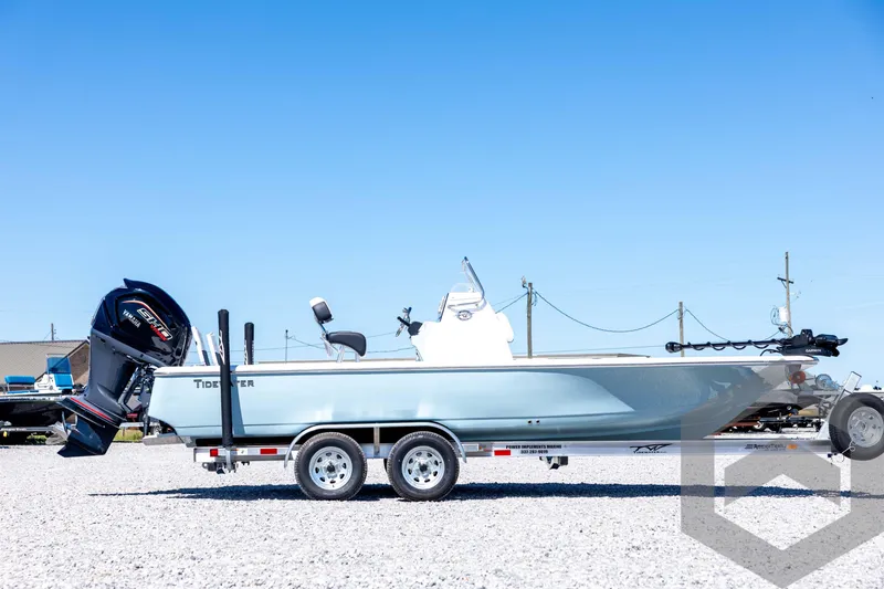 Slide: The Image of 2026 Tidewater 2110 Bay Max boat on trailer, featuring Yamaha engine, under clear blue sky. - 4