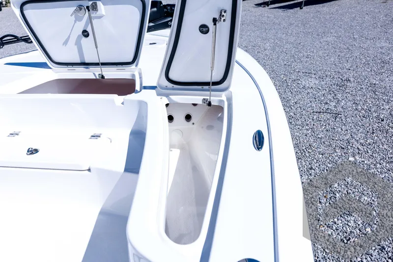 Slide: The Image of 2026 Tidewater 2110 Bay Max boat storage compartments open on gravel surface. - 41