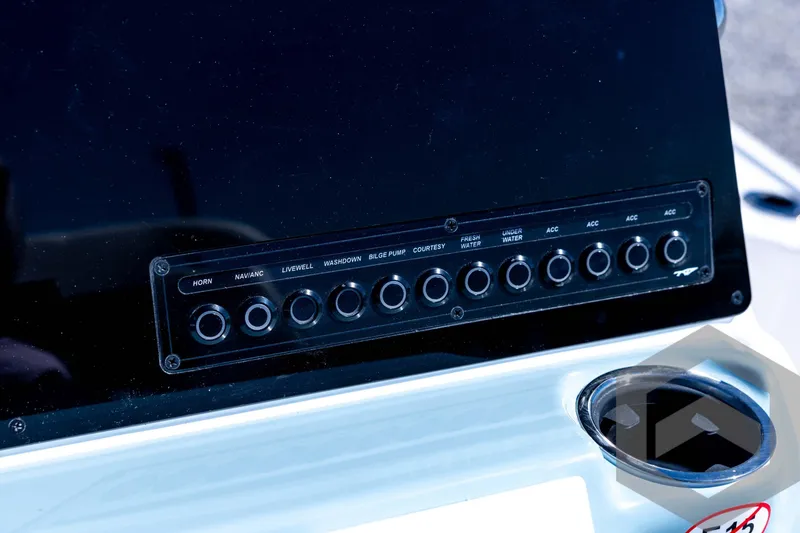 Slide: The Image of Control panel of 2026 Tidewater 2110 Bay Max boat with labeled switches. - 53