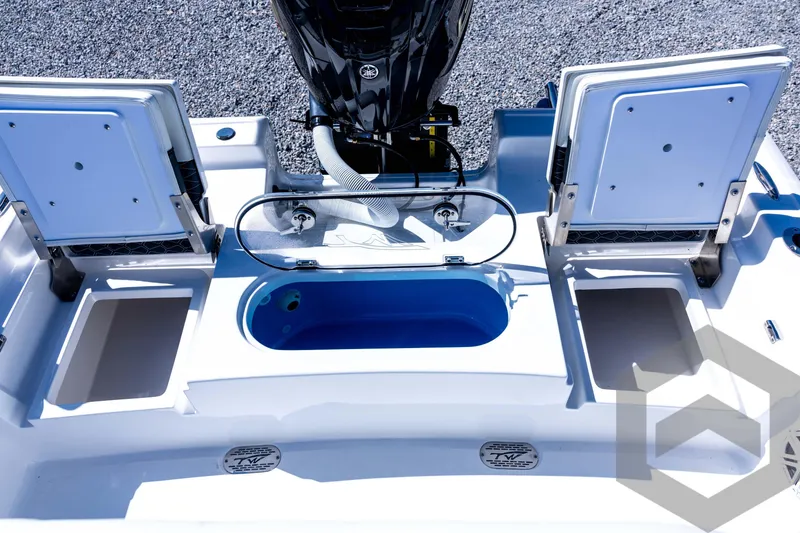Slide: The Image of 2026 Tidewater 2110 Bay Max boat interior with storage compartments and motor. - 68
