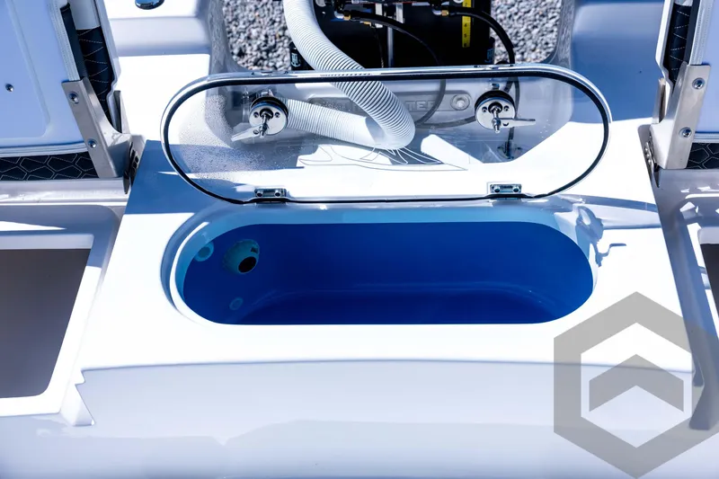 Slide: The Image of 2026 Tidewater 2110 Bay Max boat livewell with open lid and blue interior. - 70