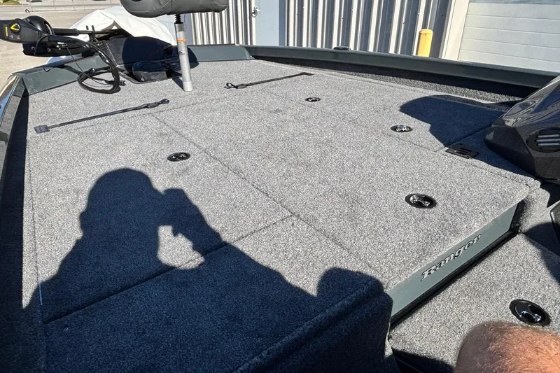 Slide: The Image of 2026 Ranger RT198P boat interior with green-accented seat and Minn Kota trolling motor. - 4