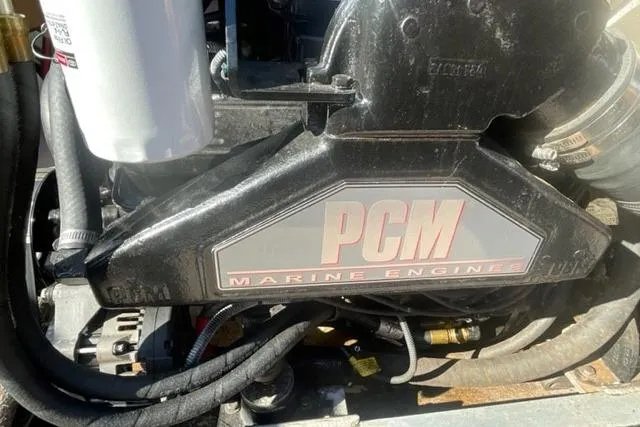 Slide: The Image of 2009 Nautique Ski Nautique 196 PCM marine engine close-up with visible components. - 13