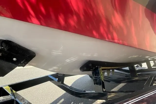Slide: The Image of 2009 Nautique Ski Nautique 196 boat hull on trailer, red and white design. - 18