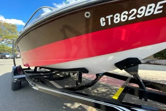 Slide: The Image of 2009 Nautique Ski Nautique 196 boat on trailer, red and white hull, side view. - 19