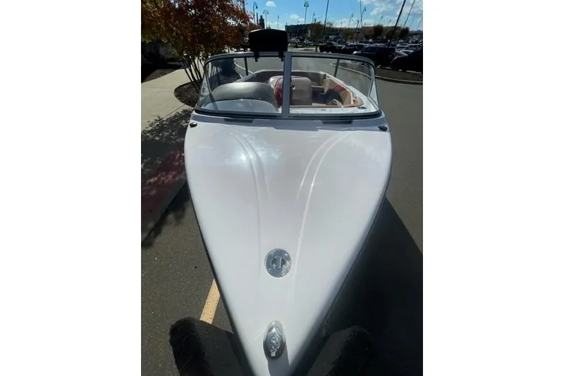 Slide: The Image of 2009 Nautique Ski Nautique 196 boat, white exterior, parked outdoors on a sunny day. - 21