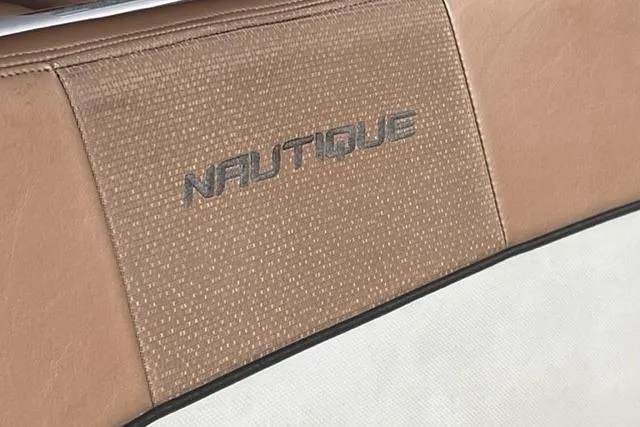 Slide: The Image of 2009 Nautique Ski Nautique 196 interior with logo on tan upholstery. - 23