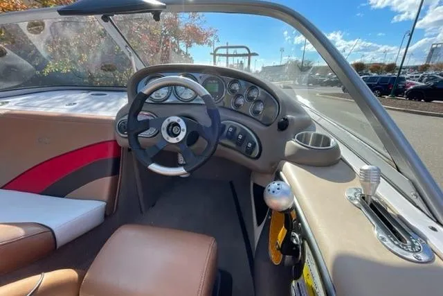 Slide: The Image of 2009 Nautique Ski Nautique 196 boat interior with steering wheel and dashboard controls. - 26