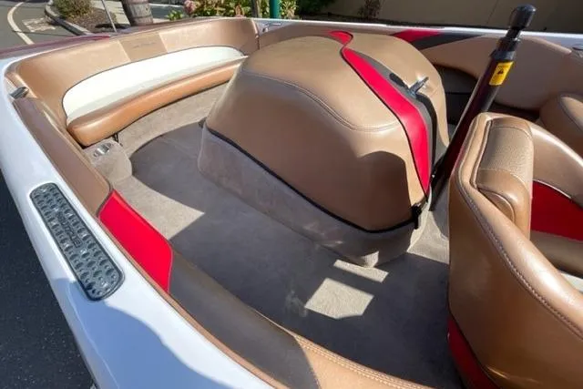 Slide: The Image of 2009 Nautique Ski Nautique 196 interior with tan and red seating, showcasing sleek design. - 3