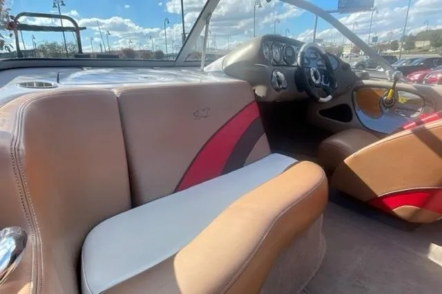 Slide: The Image of 2009 Nautique Ski Nautique 196 interior with beige and red seating, dashboard view. - 5