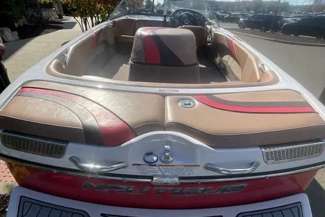 Slide: The Image of 2009 Nautique Ski Nautique 196 boat with red and beige interior, docked outdoors. - 6