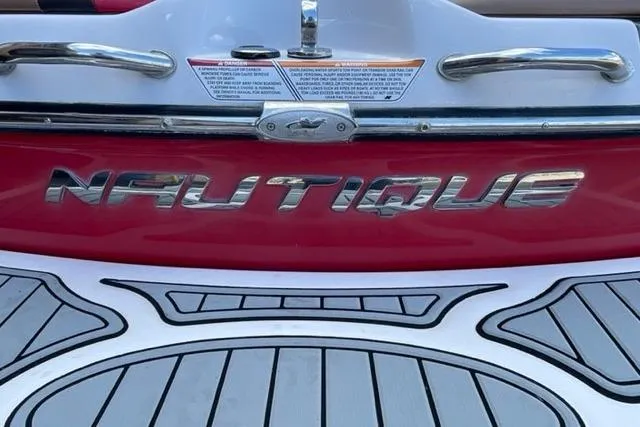 Slide: The Image of 2009 Nautique Ski Nautique 196 boat, red and white design, rear view. - 8