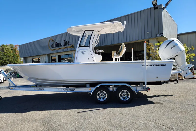 The Image of 2026 Sportsman Masters 247OE Bay Boat on trailer outside Collins Inc. dealership. - 0