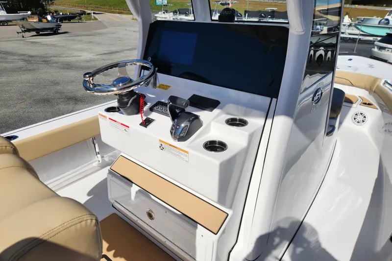 Slide: The Image of 2026 Sportsman Masters 247OE Bay Boat console with steering wheel and controls. - 12