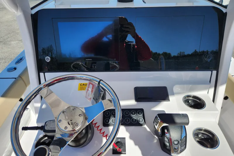 Slide: The Image of 2026 Sportsman Masters 247OE Bay Boat dashboard with steering wheel and controls. - 13