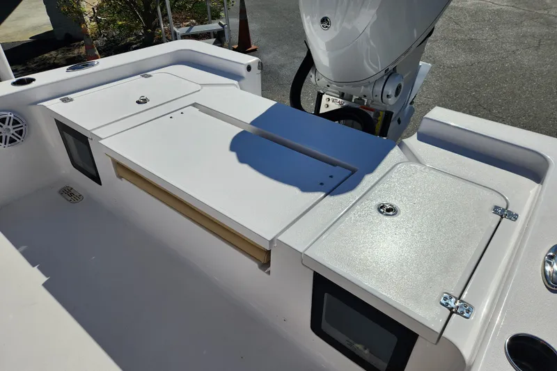 Slide: The Image of 2026 Sportsman Masters 247OE Bay Boat deck with storage compartments and motor. - 15
