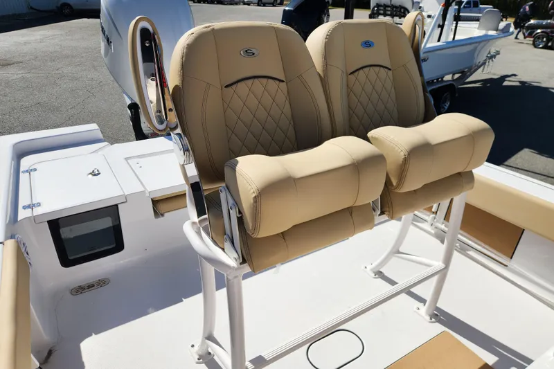 Slide: The Image of 2026 Sportsman Masters 247OE Bay Boat with tan cushioned seats and sleek design. - 18