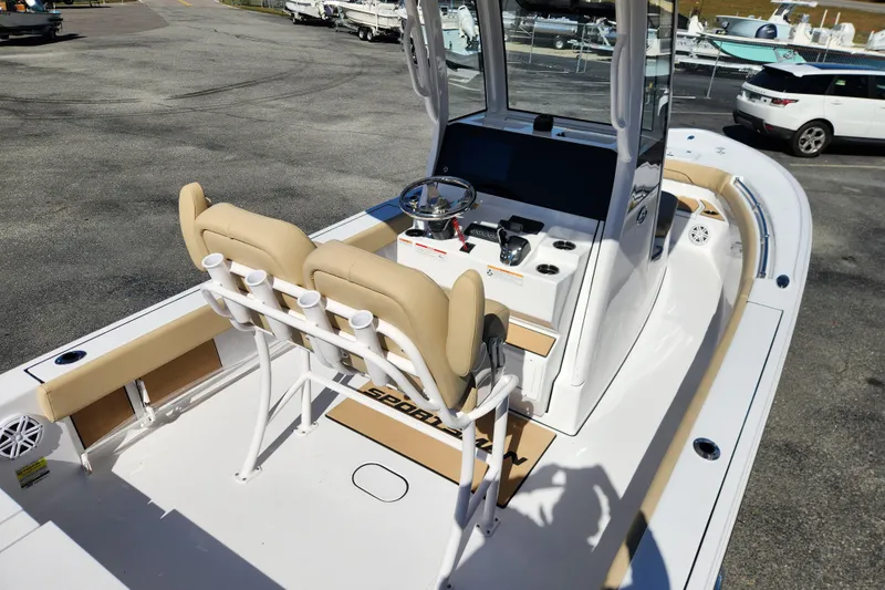 Slide: The Image of 2026 Sportsman Masters 247OE Bay Boat interior with helm and seating, parked outdoors. - 21