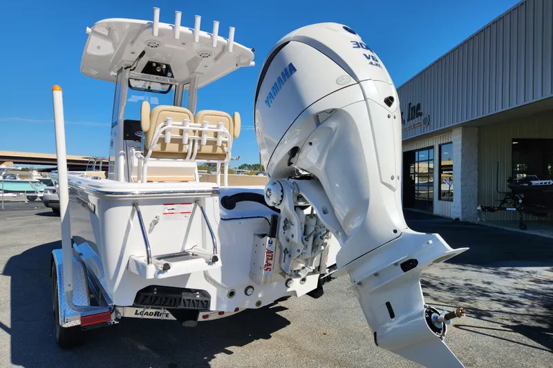 Slide: The Image of 2026 Sportsman Masters 247OE Bay Boat with Yamaha outboard motor, parked outdoors. - 3
