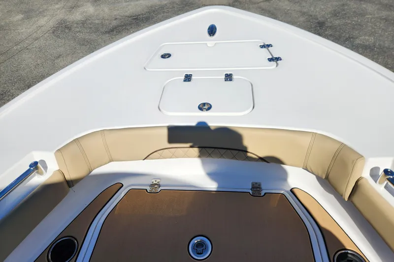 Slide: The Image of 2026 Sportsman Masters 247OE Bay Boat interior with tan seating and storage compartments. - 9