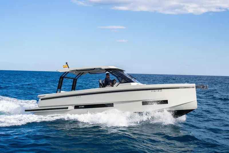 Slide: The Image of 2026 De Antonio Yachts D32 cruising on open sea under clear sky. - 5