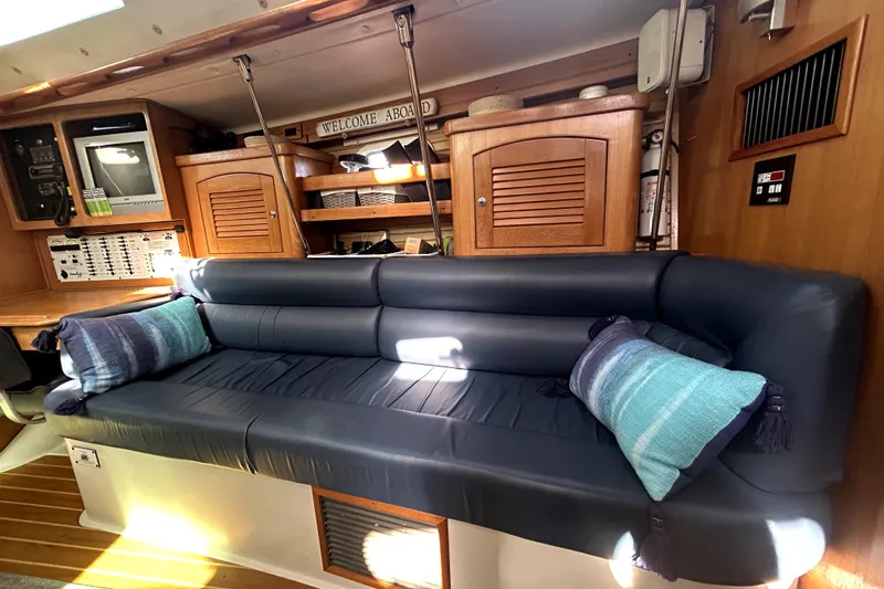 Slide: The Image of Interior of 2004 Catalina 400 MkII yacht with blue leather seating and nautical decor. - 10