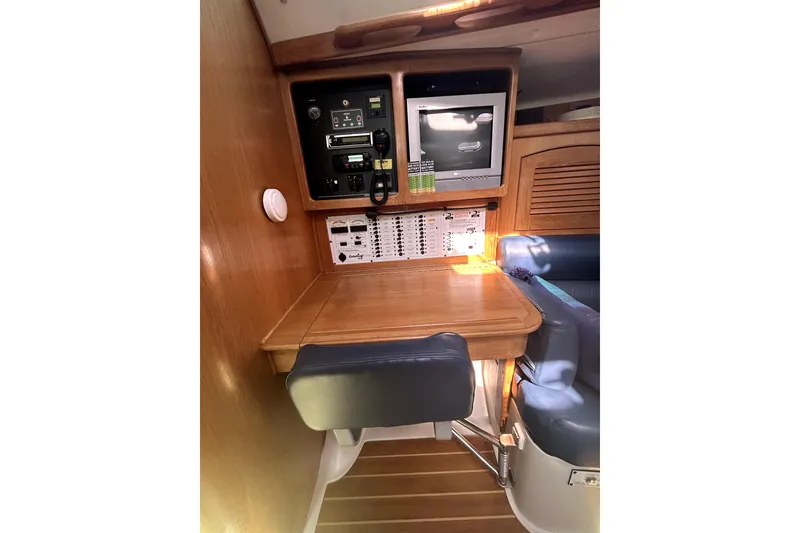 Slide: The Image of Navigation station in 2004 Catalina 400 MkII sailboat with control panel and seating. - 11
