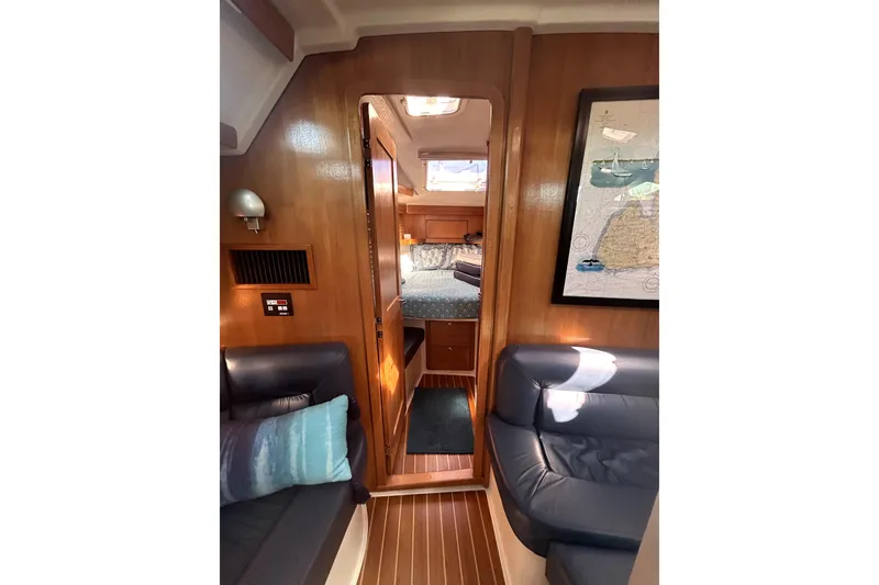 Slide: The Image of Interior of 2004 Catalina 400 MkII sailboat with cozy seating and wooden finishes. - 12