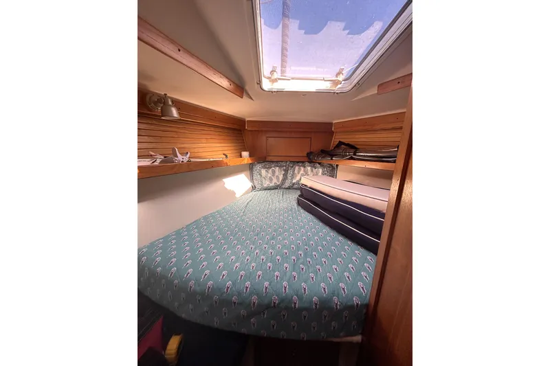Slide: The Image of Cozy cabin interior of 2004 Catalina 400 MkII sailboat with skylight and patterned bedding. - 13
