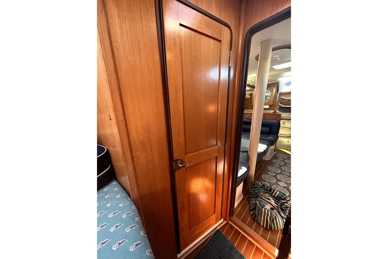 Slide: The Image of Interior of 2004 Catalina 400 MkII sailboat with wooden door and cozy seating area. - 15