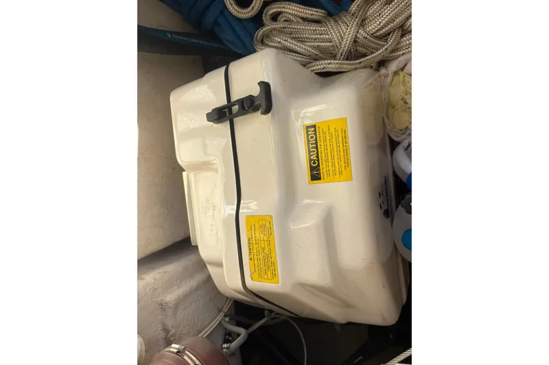 Slide: The Image of Safety equipment storage on 2004 Catalina 400 MkII sailboat, featuring caution labels and ropes. - 19