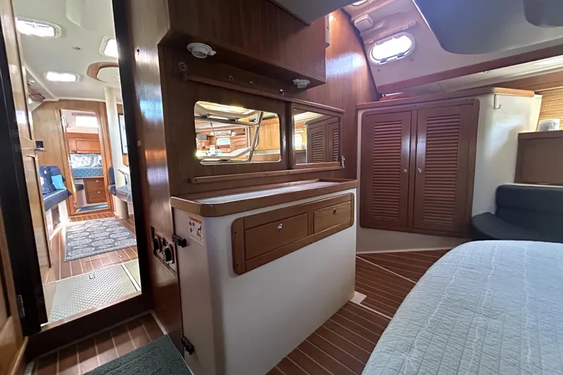 Slide: The Image of Interior of 2004 Catalina 400 MkII sailboat with wood cabinetry and cozy seating area. - 3