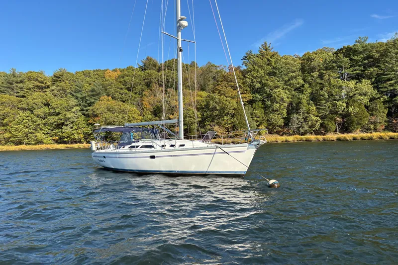Slide: The Image of Catalina 400 MkII 2004 sailboat anchored on a scenic lake with forested shoreline. - 31