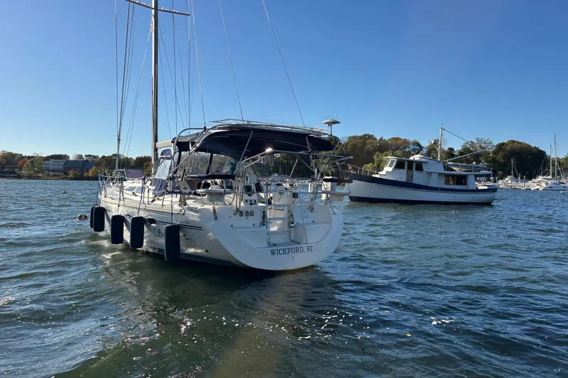 Slide: The Image of 2004 Catalina 400 MkII sailboat anchored in a scenic harbor. - 32