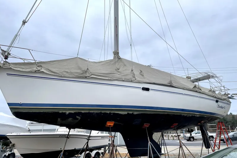 Slide: The Image of 2004 Catalina 400 MkII sailboat on stands, covered, with overcast sky. - 34