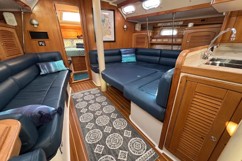 Slide: The Image of Interior of 2004 Catalina 400 MkII yacht with cozy seating and wooden finishes. - 7