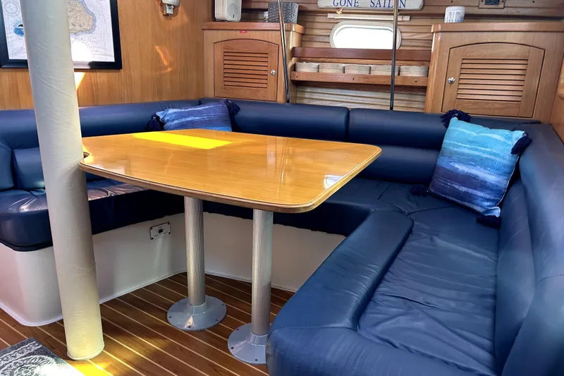 Slide: The Image of Interior of 2004 Catalina 400 MkII sailboat with blue seating and wooden table. - 9