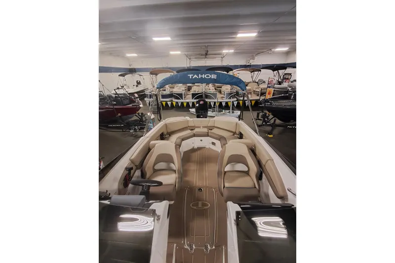 Slide: The Image of 2026 Tahoe 210 S boat in showroom, featuring spacious seating and sleek design. - 7