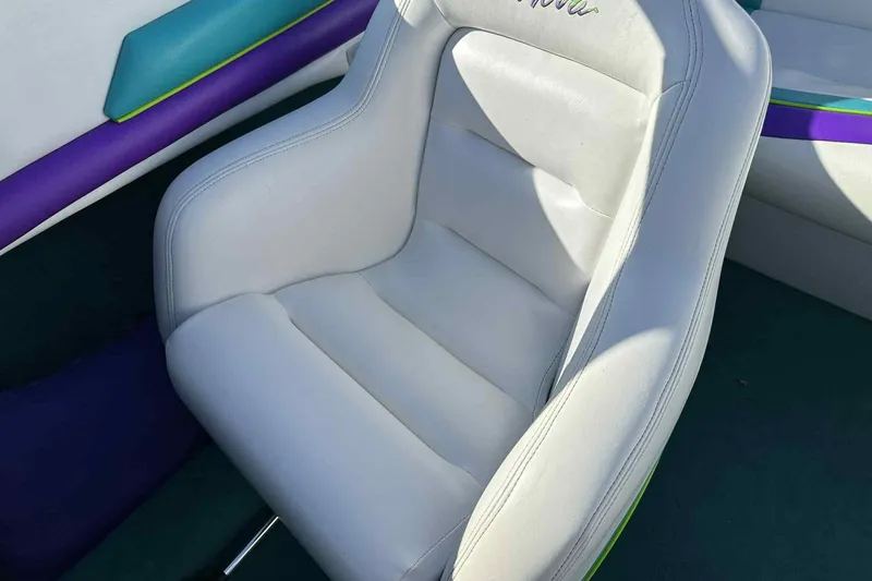 Slide: The Image of White leather seat in 1993 Nova Spyder boat, with colorful interior accents. - 11