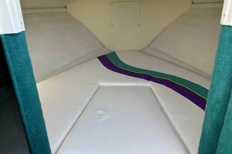 Slide: The Image of 1993 Nova Spyder boat interior with colorful striped upholstery. - 2