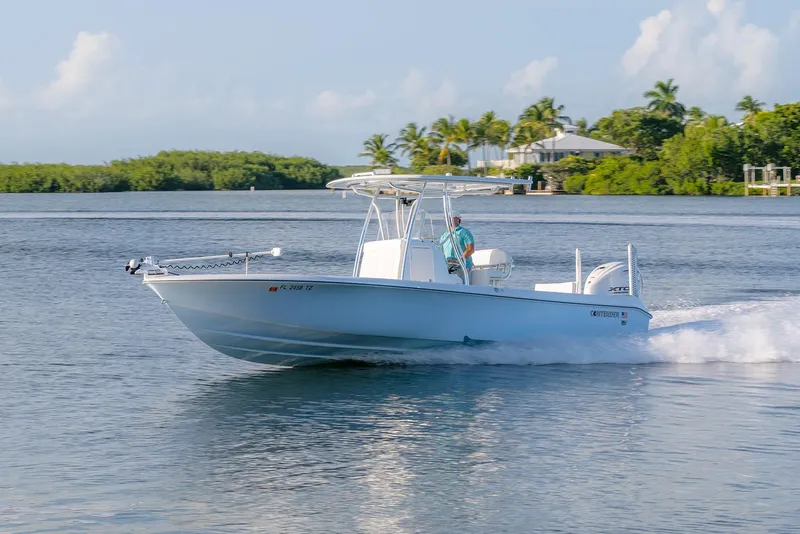 The Image of 2025 Contender 29 Bay boat cruising on a scenic waterway. - 1