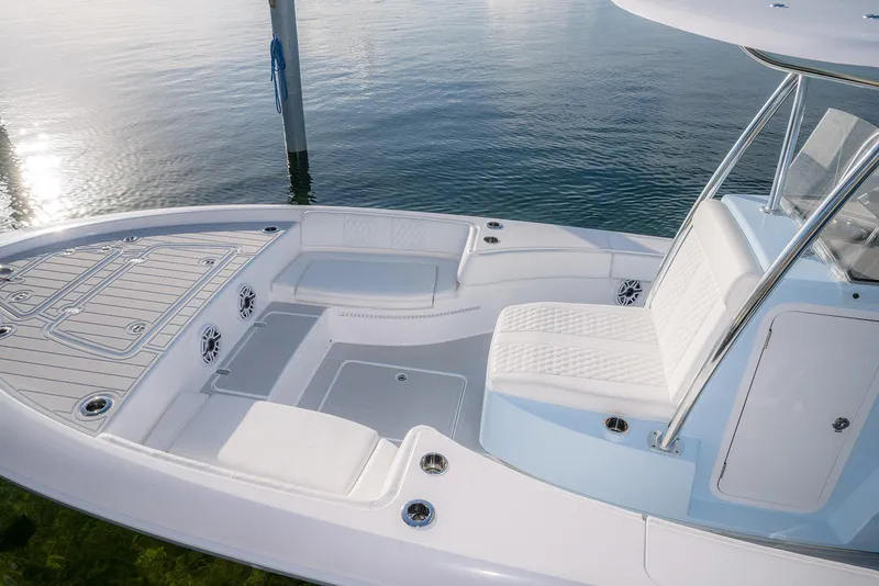 Slide: The Image of 2025 Contender 29 Bay boat interior with white seating and sleek design on calm water. - 12