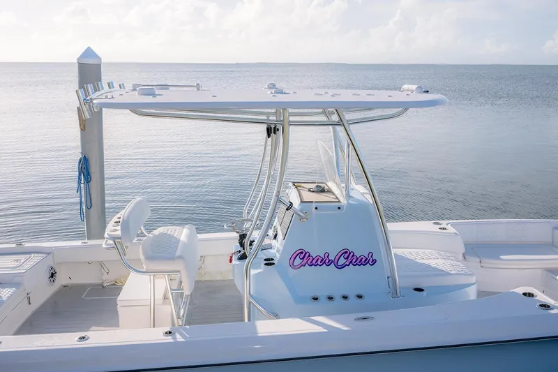 Slide: The Image of 2025 Contender 29 Bay boat docked, featuring sleek design and spacious seating. - 17