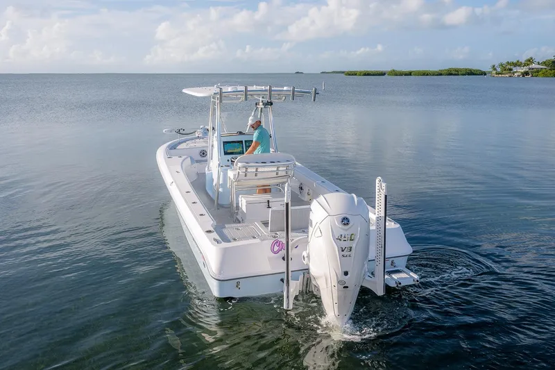 Slide: The Image of 2025 Contender 29 Bay boat cruising on calm water under a clear sky. - 19
