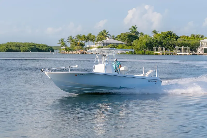 Slide: The Image of 2025 Contender 29 Bay boat cruising on a sunny day near tropical shoreline. - 3