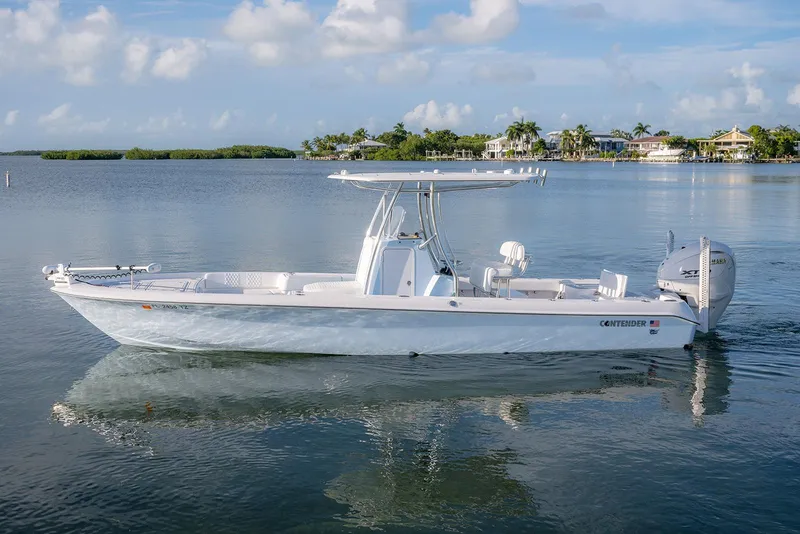 Slide: The Image of 2025 Contender 29 Bay boat on calm water, clear sky, coastal background. - 8