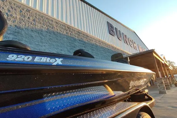 Slide: The Image of 2026 Phoenix 920 Elite X boat parked outside a building at sunset. - 14