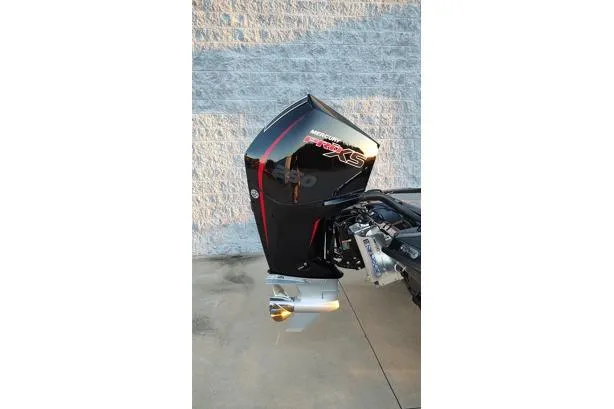 Slide: The Image of Outboard motor on a 2026 Phoenix 920 Elite X boat, parked on concrete. - 16
