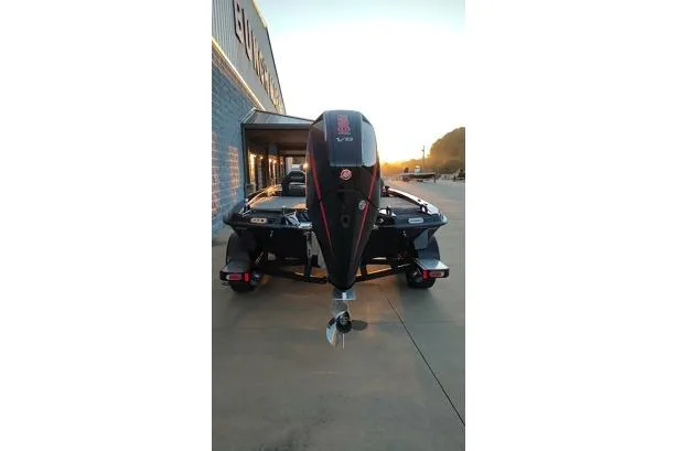 Slide: The Image of 2026 Phoenix 920 Elite X boat with powerful outboard motor, parked outdoors at sunset. - 17