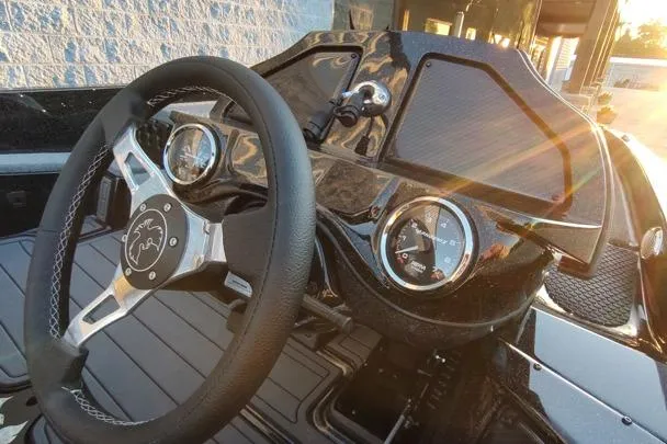 Slide: The Image of Steering wheel and dashboard of 2026 Phoenix 920 Elite X boat in sunlight. - 7